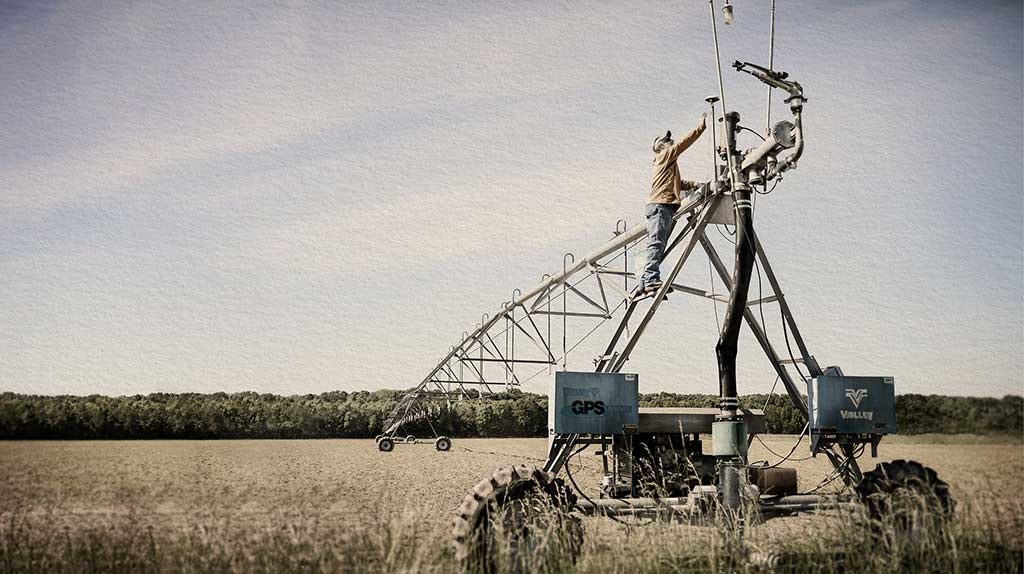 Farm Safe advertisement showing farmer working on irrigation system