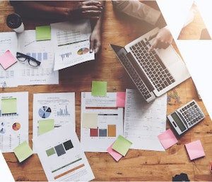 top view of desk with calculator and papers